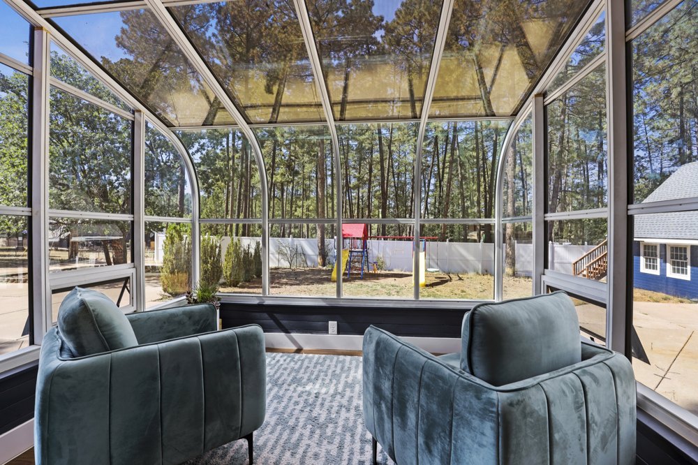 A bright sitting room overlooking the pines at Strawberry Pines Retreat.